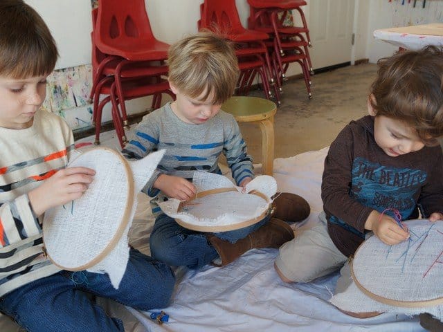 three boys sewing